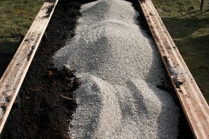 Foto, hvor der tilsættes vermiculite til jorden.